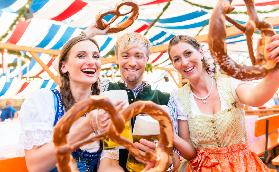 People enjoying beer and pretzel during Oktoberfest in Germany