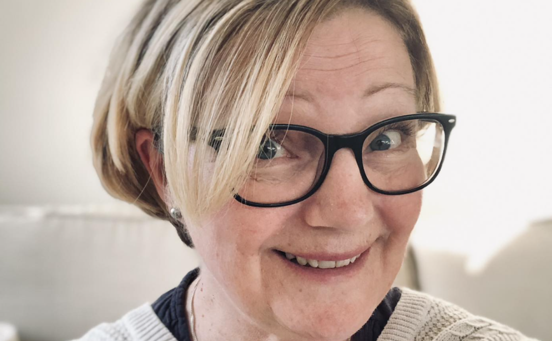 A person taking a selfie and smiling