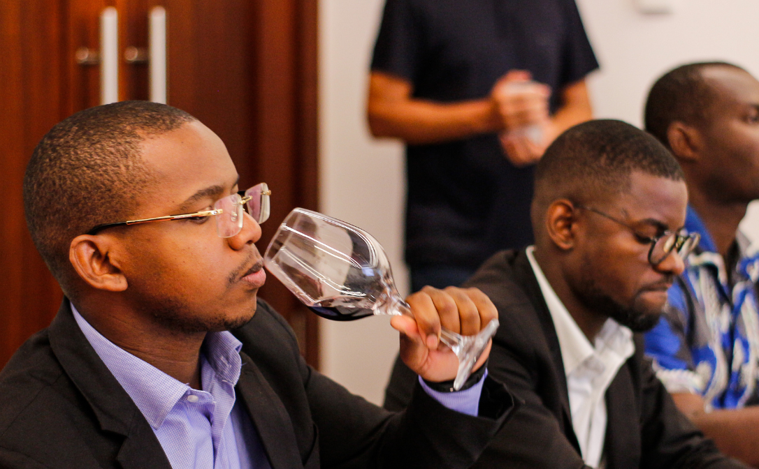 Man smells glass of red wine