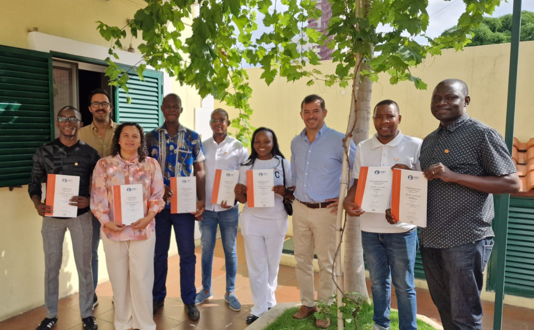 A group of graduates with their certificates in Angola