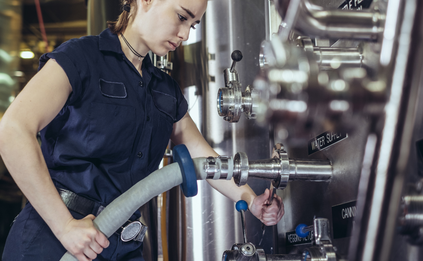 Woman pumping beer from a tank