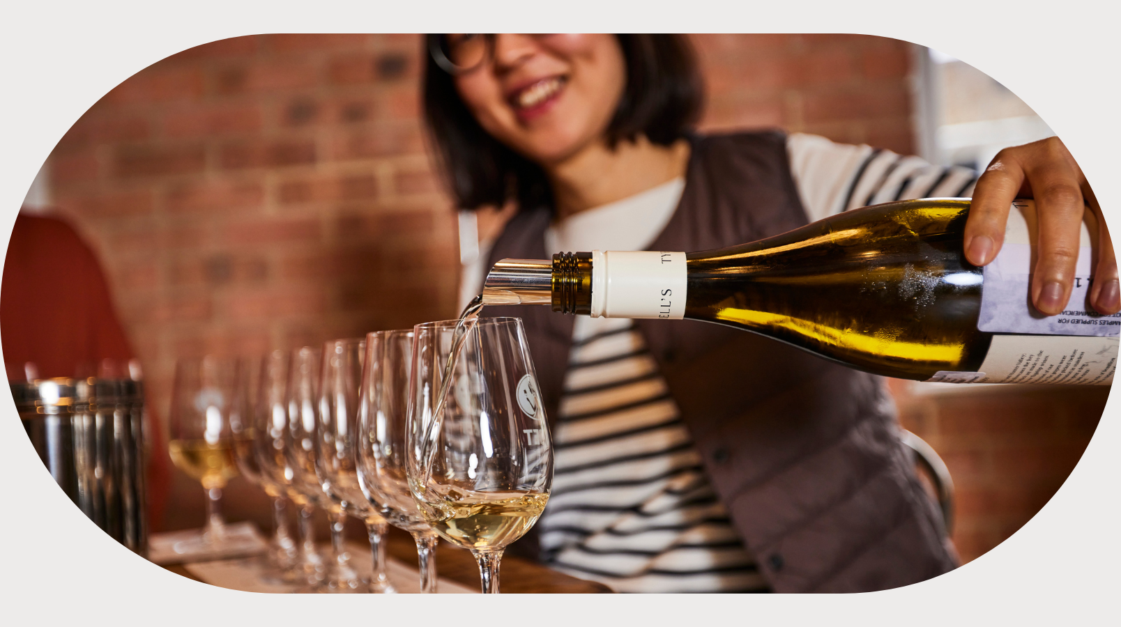 A wset student pouring wine.