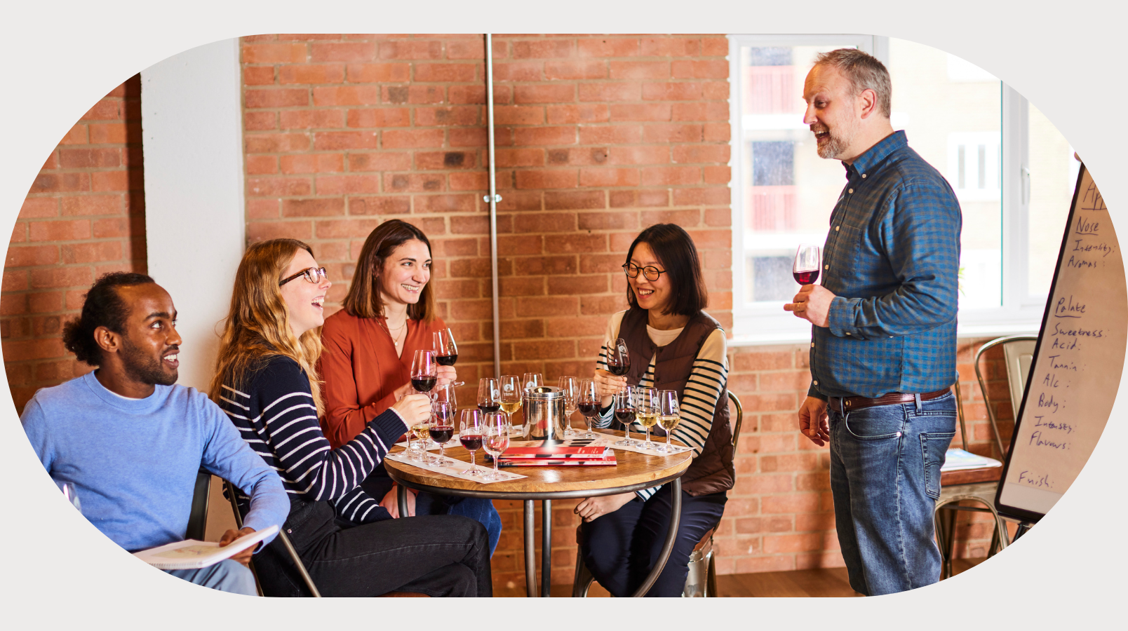 A classroom of wset wine students and their teacher.