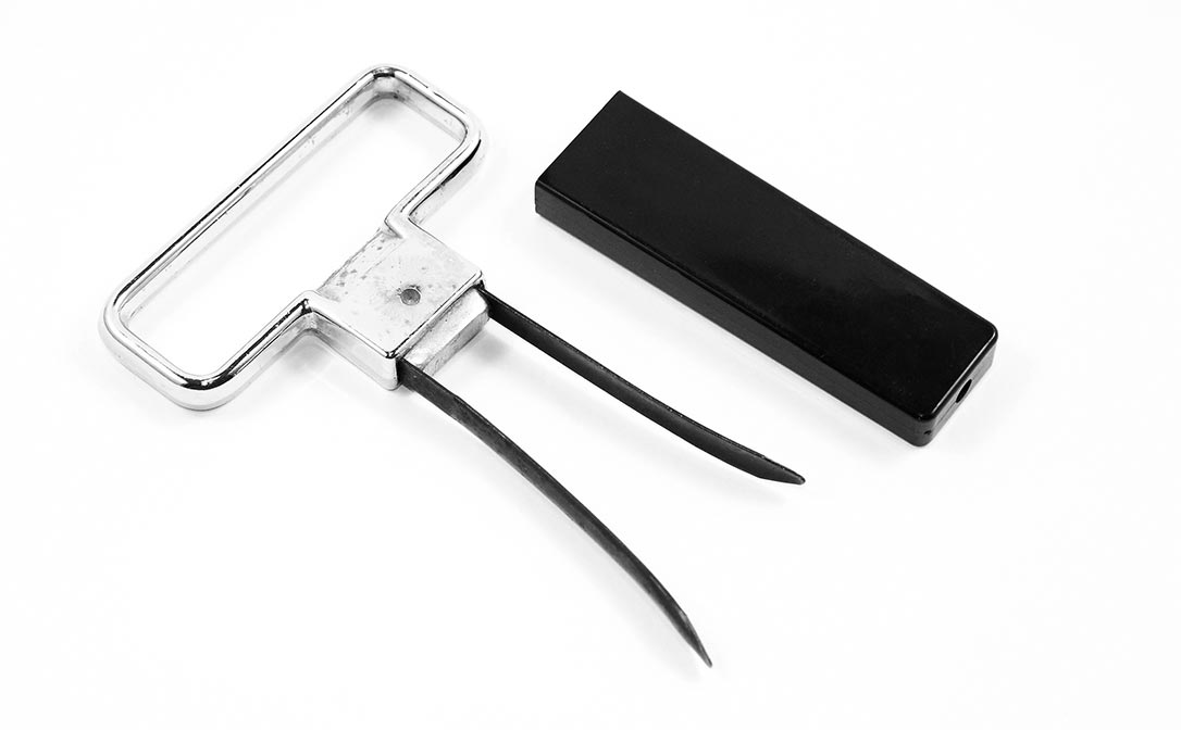 Two-prong "Ah-So" cork puller on a plain white background.